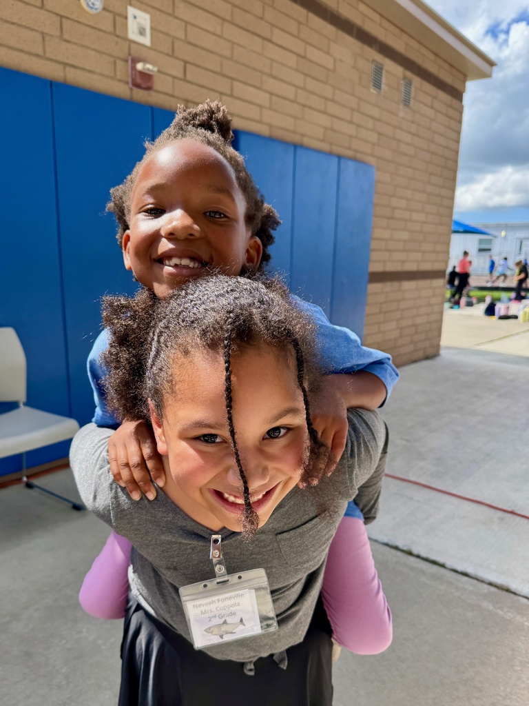 Two students wearing their biggest smiles 