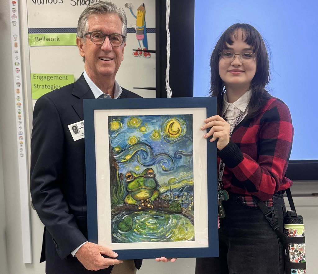 State Senator Jim Boyd congratulates a young artist for winning the Congressional Art Contest