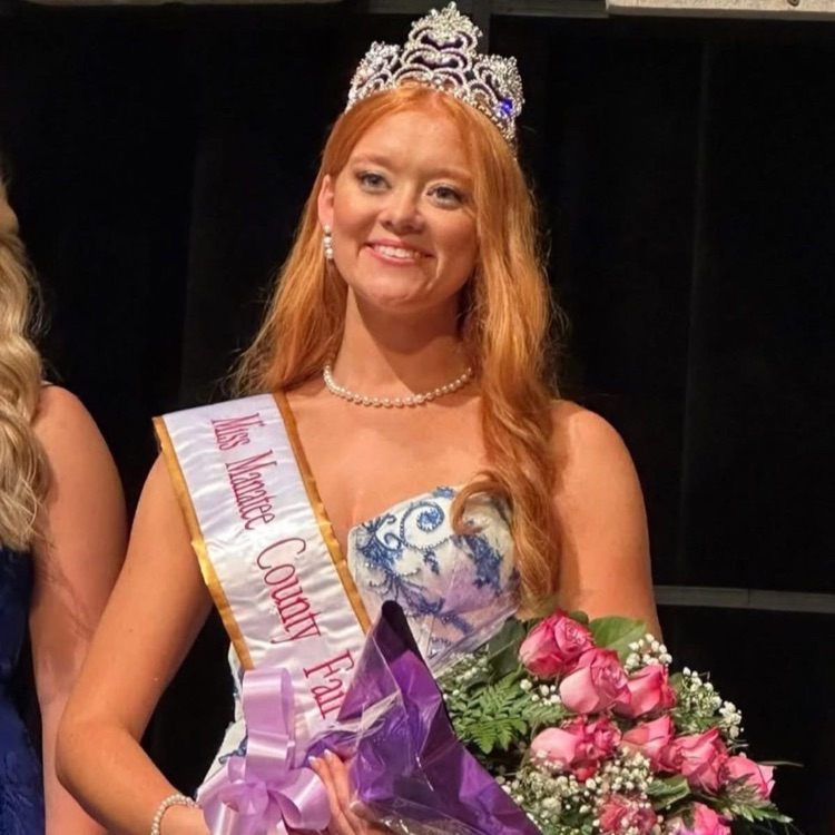 a young woman wearing a crown and holding pink roses