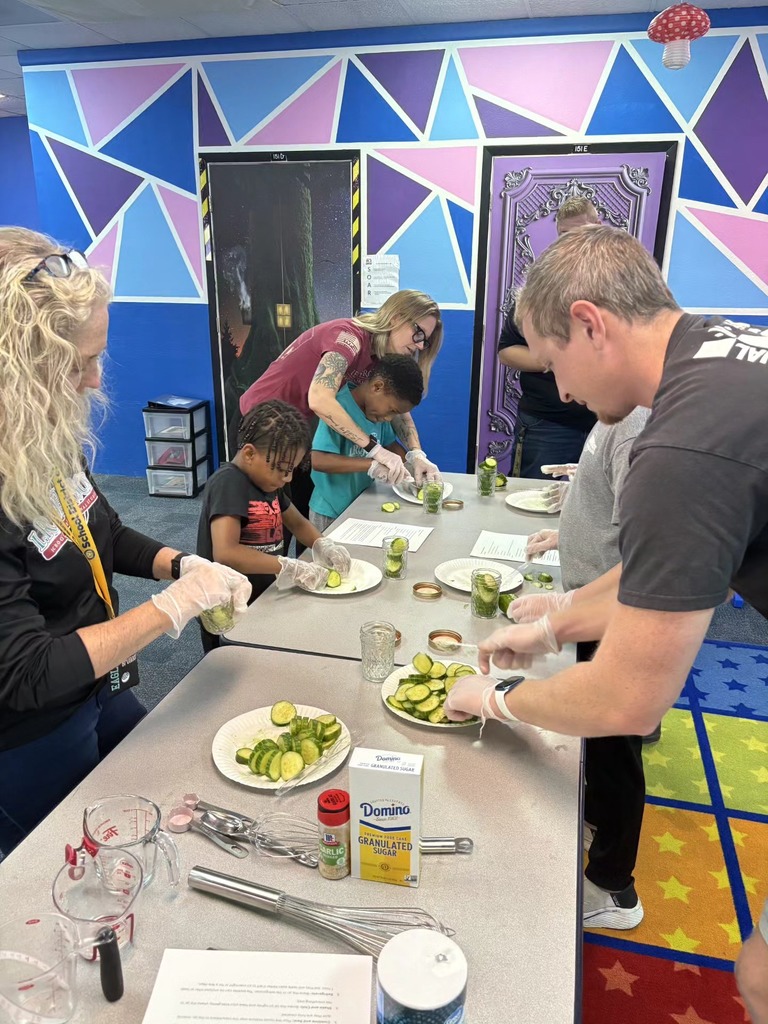 Students and staff turn cucumbers into pickles.