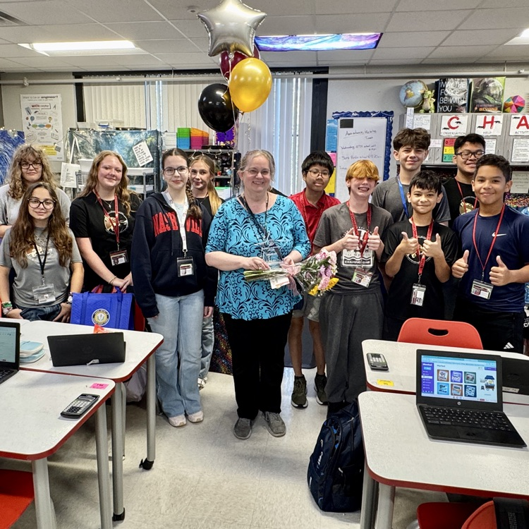 A teacher of the year finalist smiling with her students