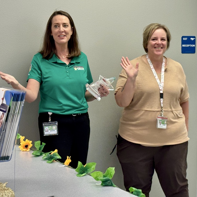 The superintendent, surprises and employee with an award
