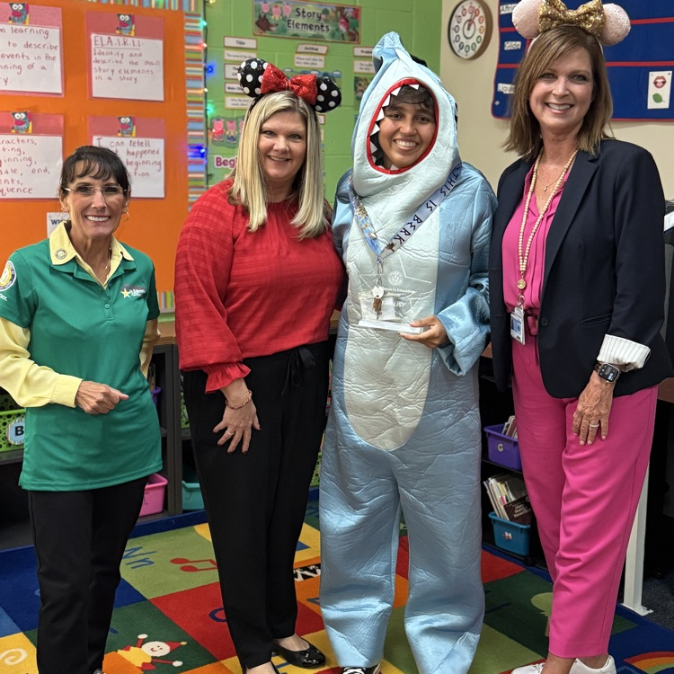 School administrator with an employee who is just announced as finalist for employee of the year