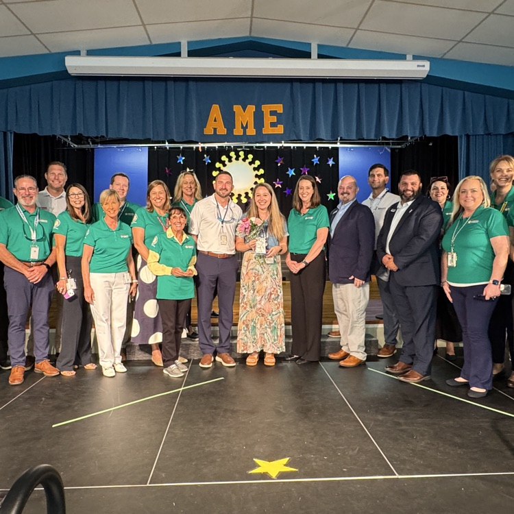A group of school district leaders surprises a teacher of the year finalist