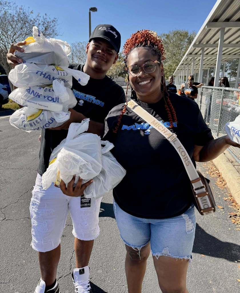 Volunteers holding hot food they'll pass out to cars during a special event at Lincoln Memorial Middle School.