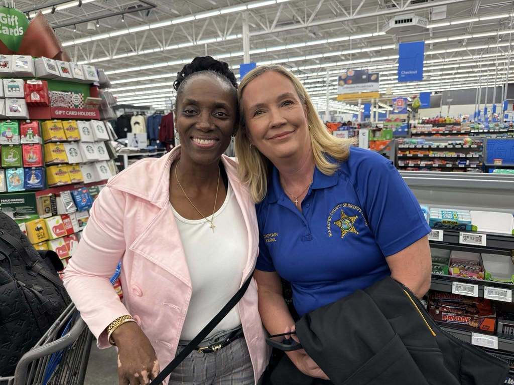 a school employee and sheriff's office captain go shopping with kids for christmas wishes.