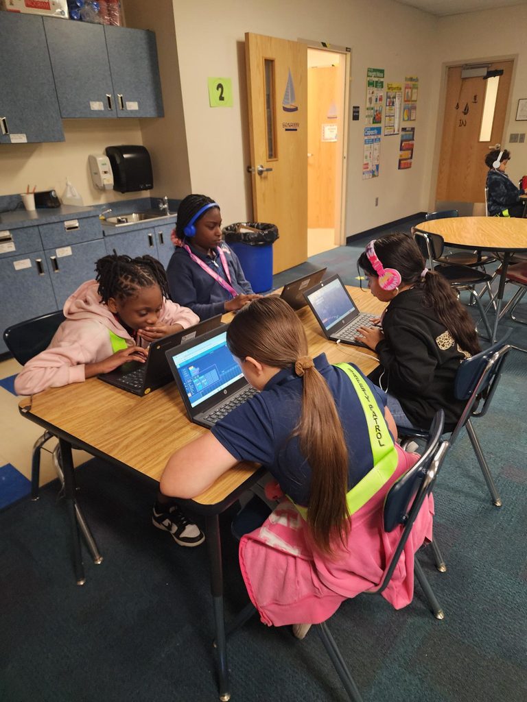 Elementary students creating their own music during a special activity for Hour of Code.