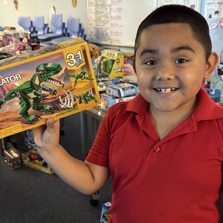 A little boy holding a Lego set, he received at Santa’s workshop