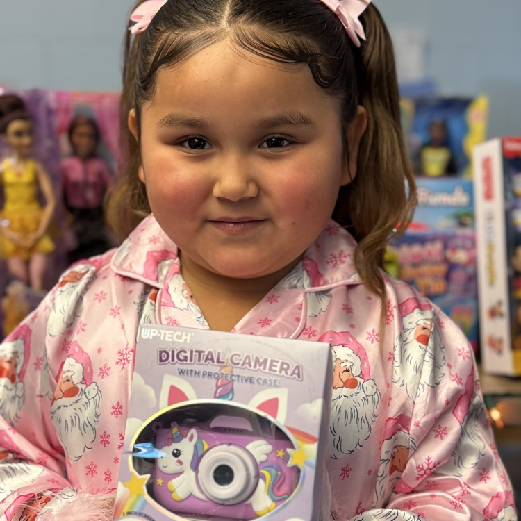 A little girl holding a toy digital camera