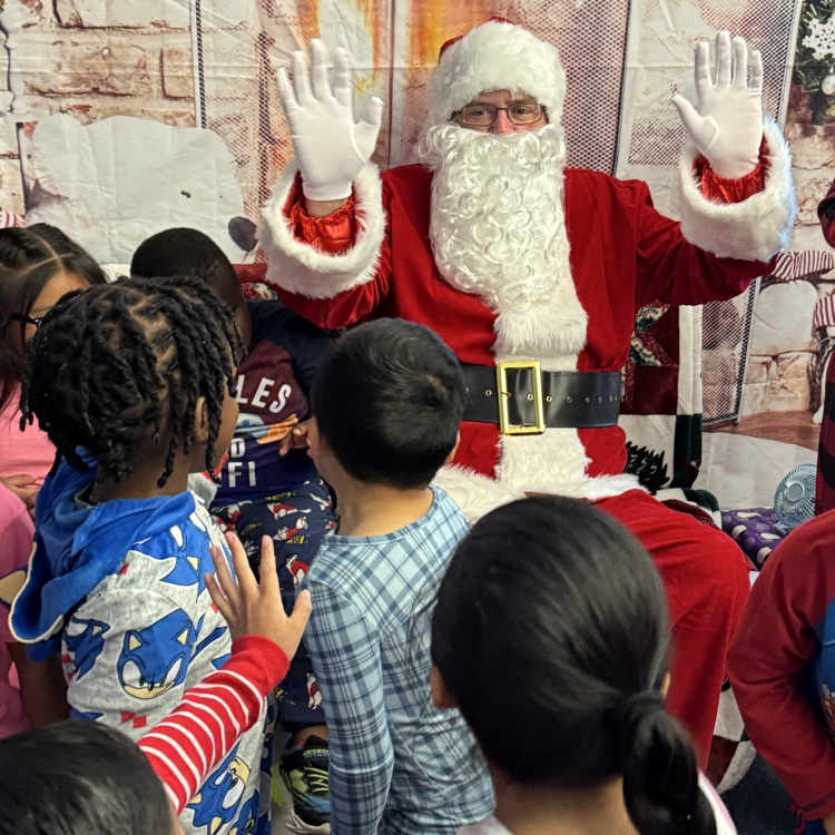 Santa giving me a high five to a student