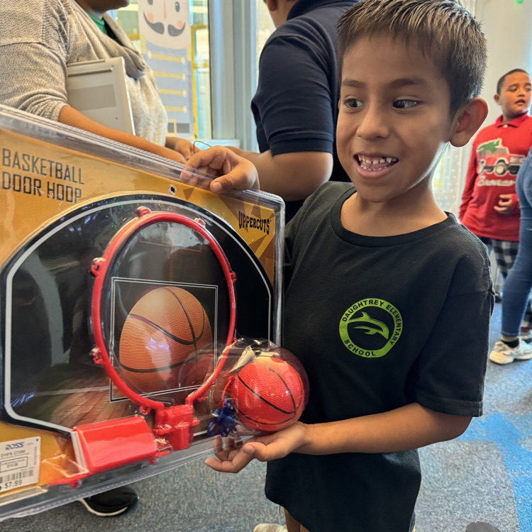 A boy happy about receiving a basketball for Christmas
