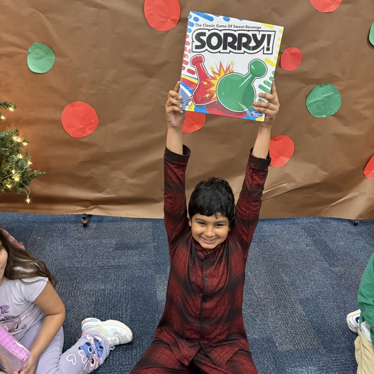 each child holds up a new board game he received for Christmas