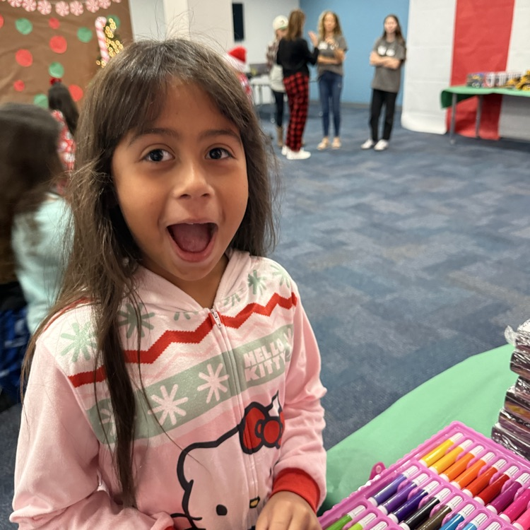 A young girl surprised that she received an art set for Christmas