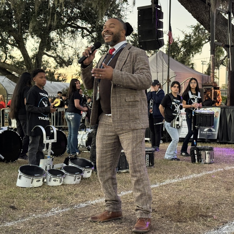 A music educator serving as master of ceremony during a drum competition