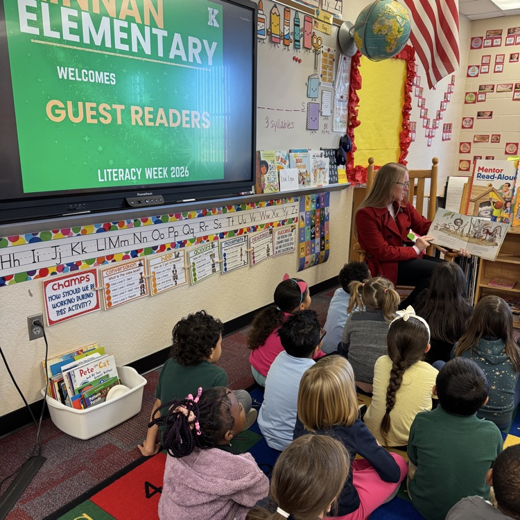 A guest reader in a classroom filled with student students