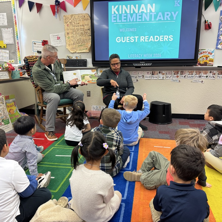 A special guest reads to students as a sign language translator relays the book to a deaf student