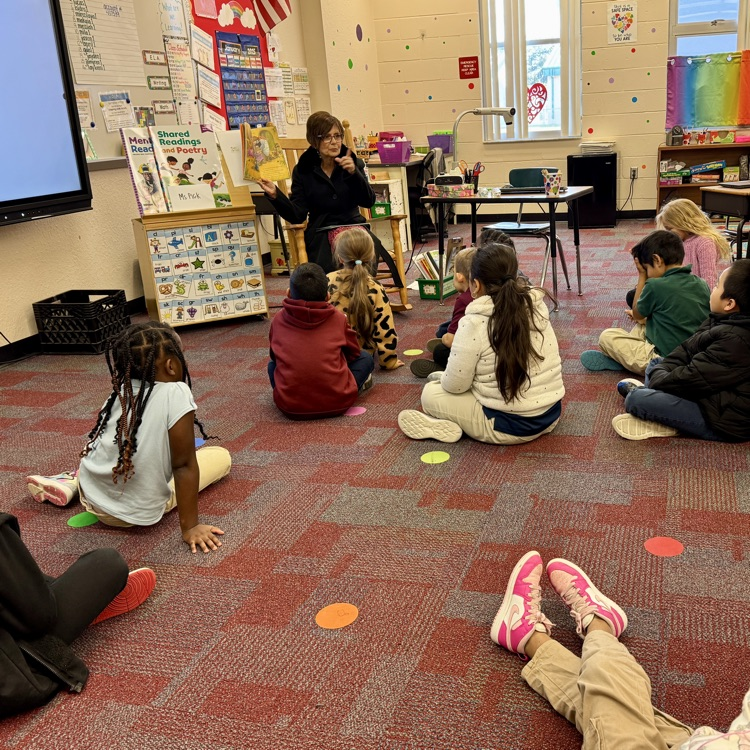 A guest reader in a classroom during literacy week