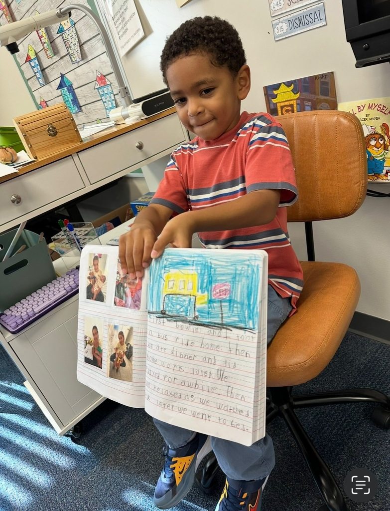 A boy shares his journal entry with classmates.