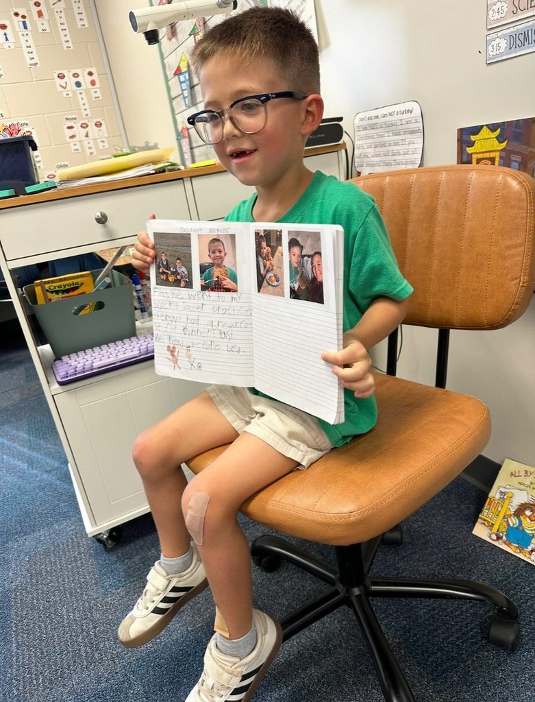 A young boy reads to classmates.