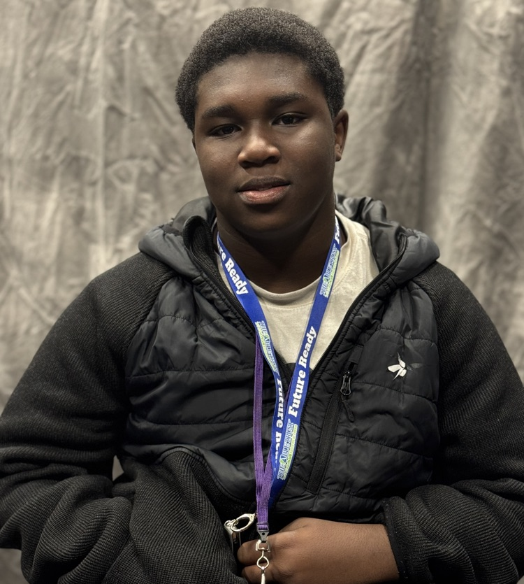 A portrait of a young man in a black sweatshirt