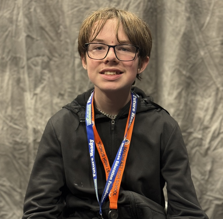 A portrait of a young man with glasses