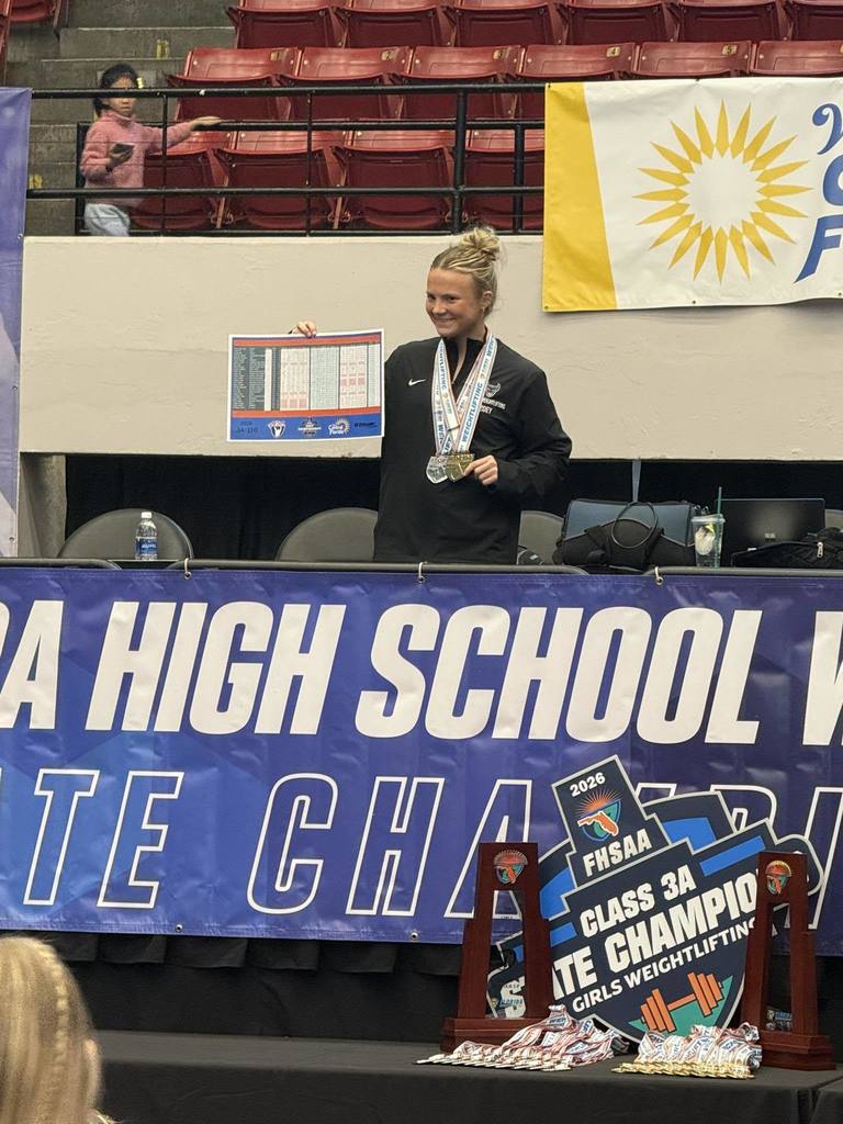 A student athlete holds up a bracket at the FHSAA Class 3A State Championship Girls Weightlifting tournament.