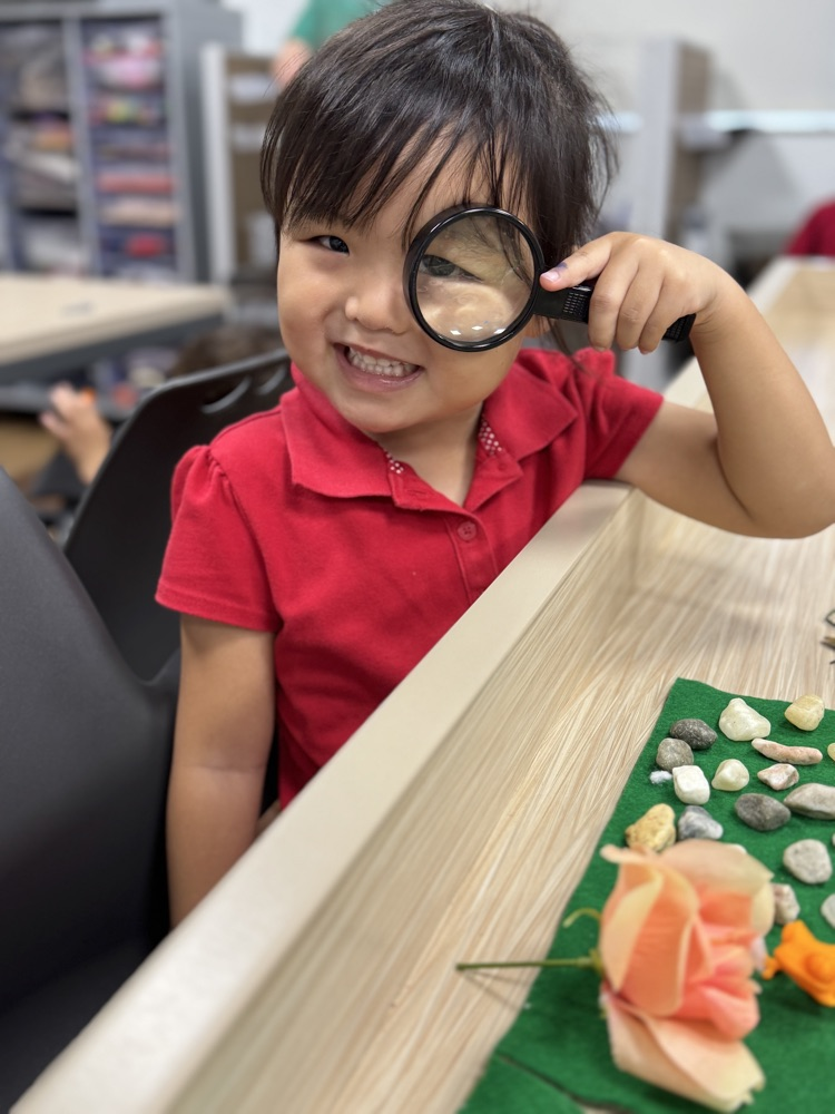 A little girl pees through a magnifying glass