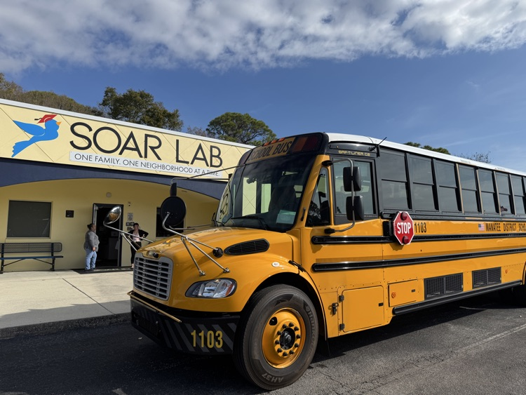 A school bus parked outside of the Soar Lab