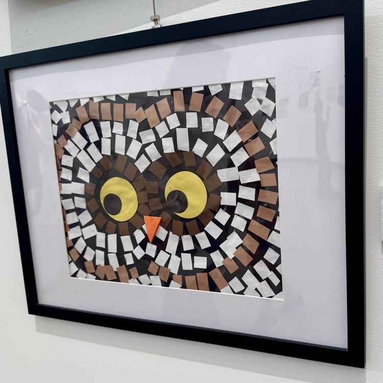 A paper collage on display titled night owl from a student