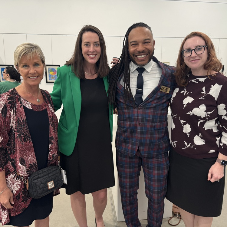 School district leaders attend a student art gallery exhibit