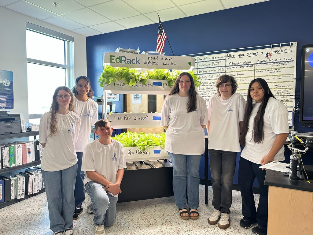 Students smiling in a classroom.