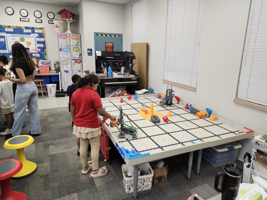 A girl learning robotics in an elementary school STEAM lab.