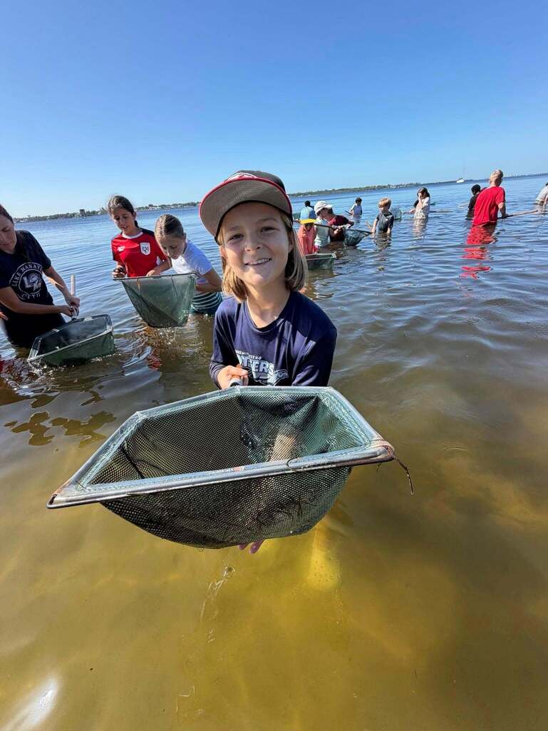 Student uses drip net during field trip to Emerson Point.