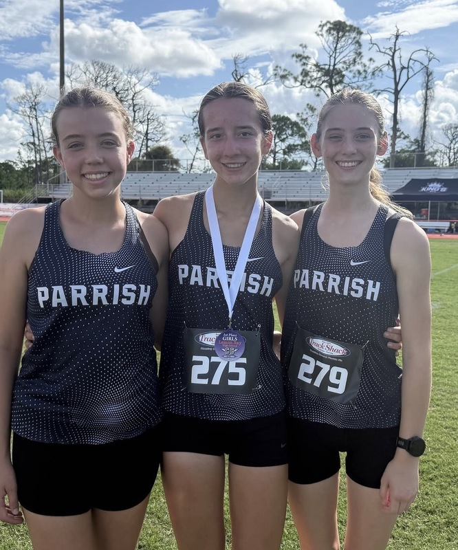 Kayla Hawk with two of her teammates after her first place finish