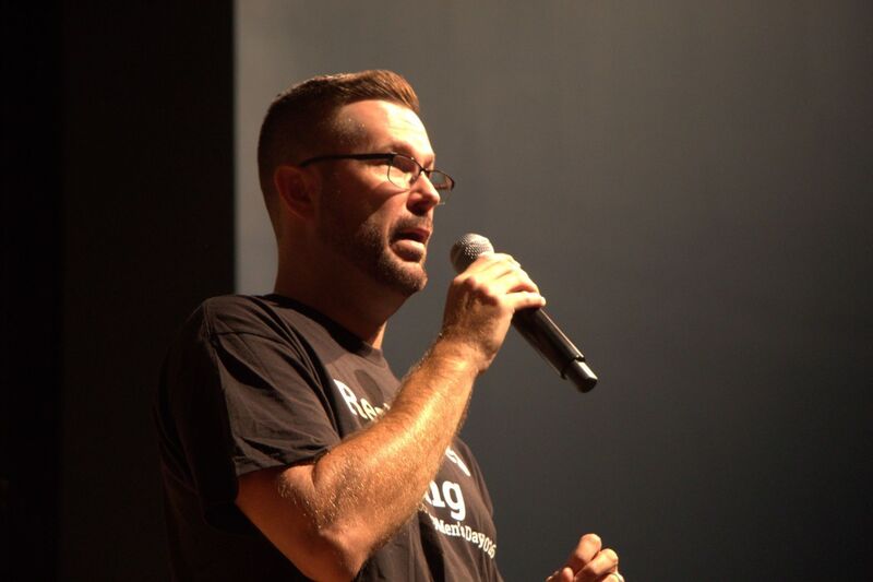A music educator speaks into a microphone.