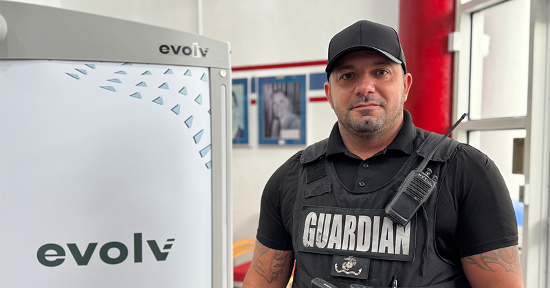 A guardian stands next to an evolv detection system.