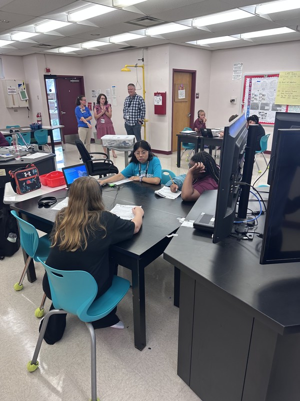 School administrators observe a science classroom.