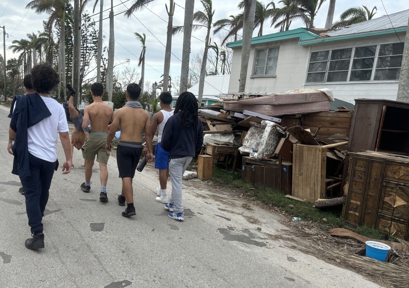 Archive photo of high school wrestlers helping clean up aftermath of hurricanes.