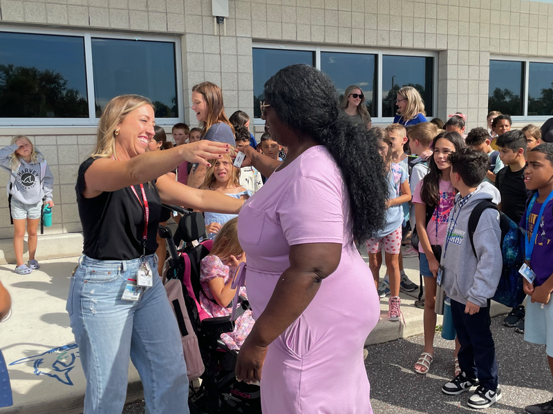 A staff member goes in to hug Laron, a paraprofessional