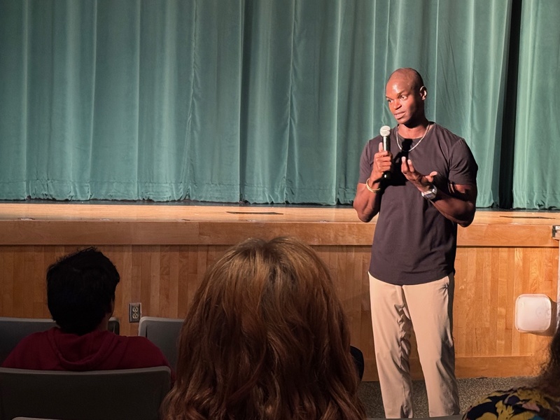 Performer speaking to high school students.
