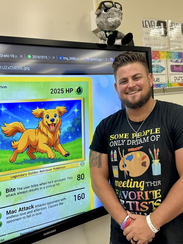 an art teacher wearing a colorful T-shirt stands next to a TV screen showing a Pokémon card