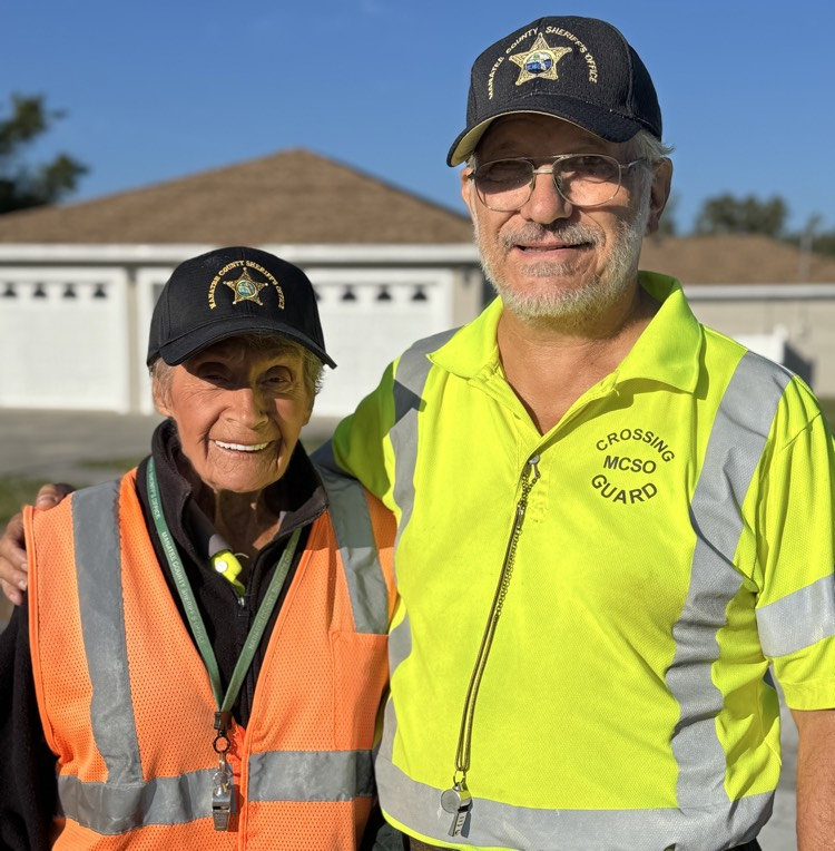 two crossing guard smile near Palma Sola elementary school