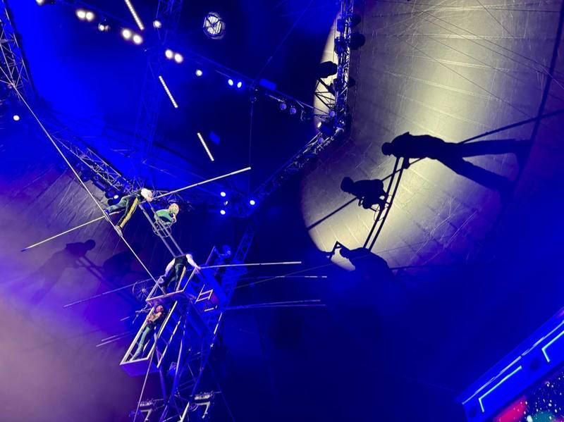 Nik Wallenda and team walk the high wire at Wonderland UTC with a large shadow of their wire walk on the tent.