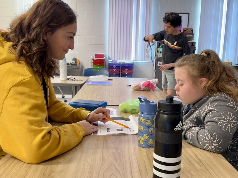 A peer partner works with another student at Parrish Community High School