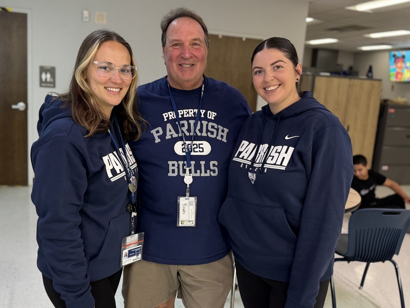 Three teachers wearing blue sweatshirts at Parrish Community High