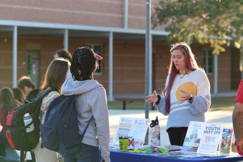 A community partner speaks with high school students.