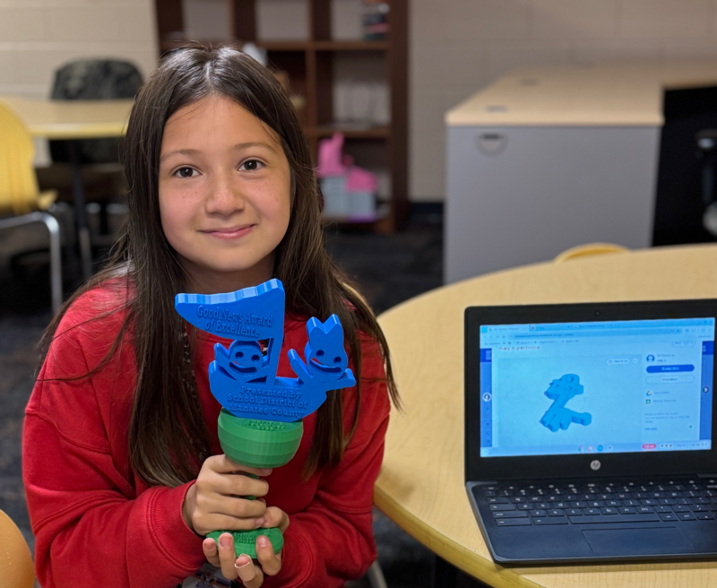 a young girl holding a trophy