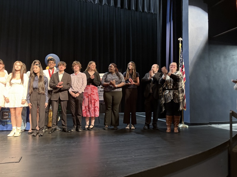 Students on stage during a science fair awards ceremony