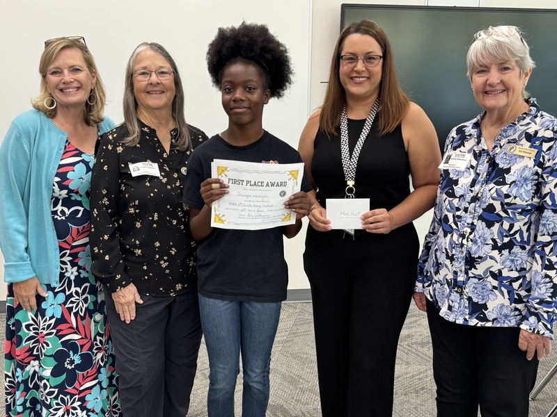 A group of women standing shoulder to shoulder and smiling