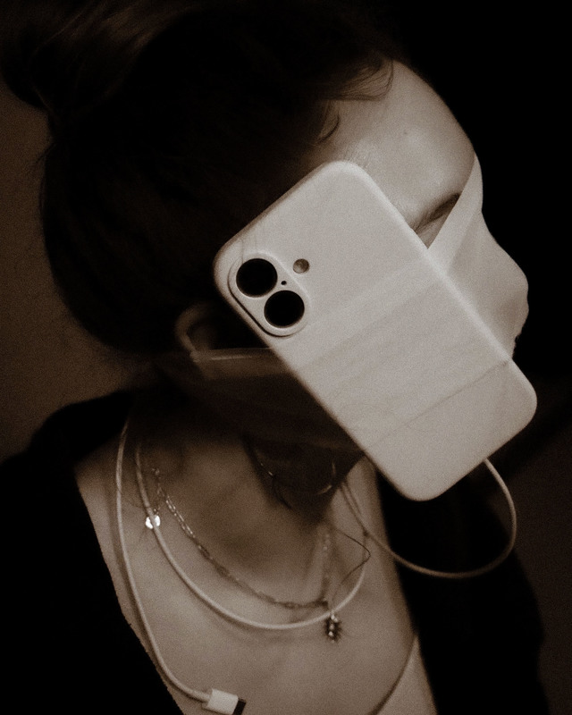 Jayanna Andre's Personal Portrait of a cellphone wrapped to a students' face